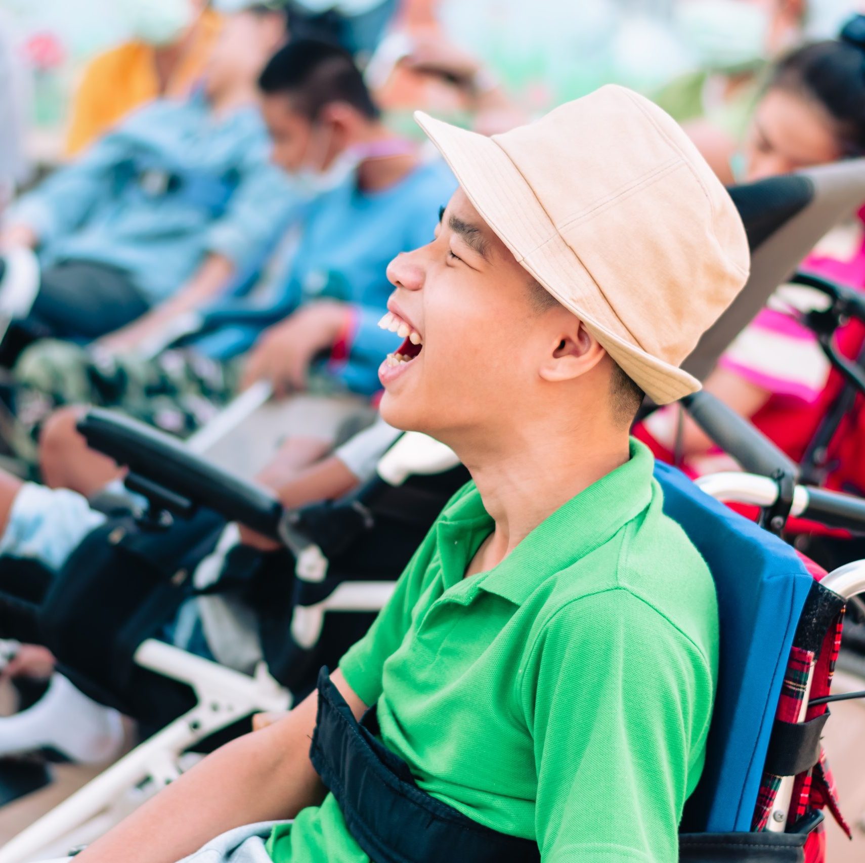PBS child in wheelchair is playing, learning and exercise in the outdoor park with friends and teacher. Portsmouth PBS Network.