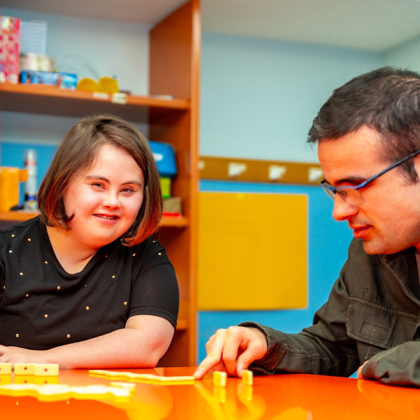 People with special needs playing board skill games in a community centre. Portsmouth PBS Network.